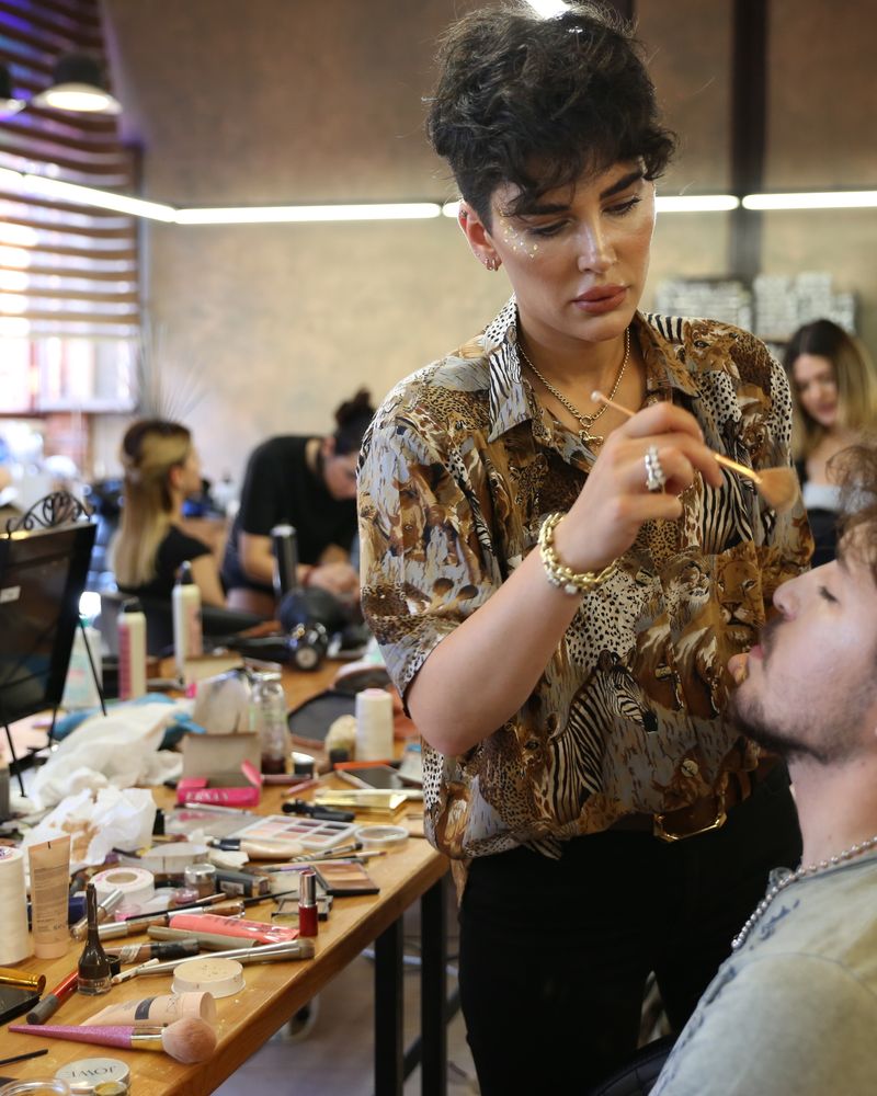 A creative team working backstage at a beauty shoot