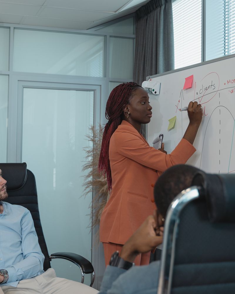 Marketing lead writing on a whiteboard in a planning session